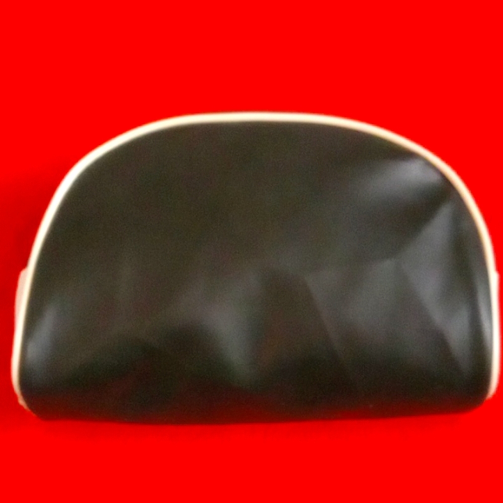 Lancome black and white cosmetic bag with a smaller pink pouch